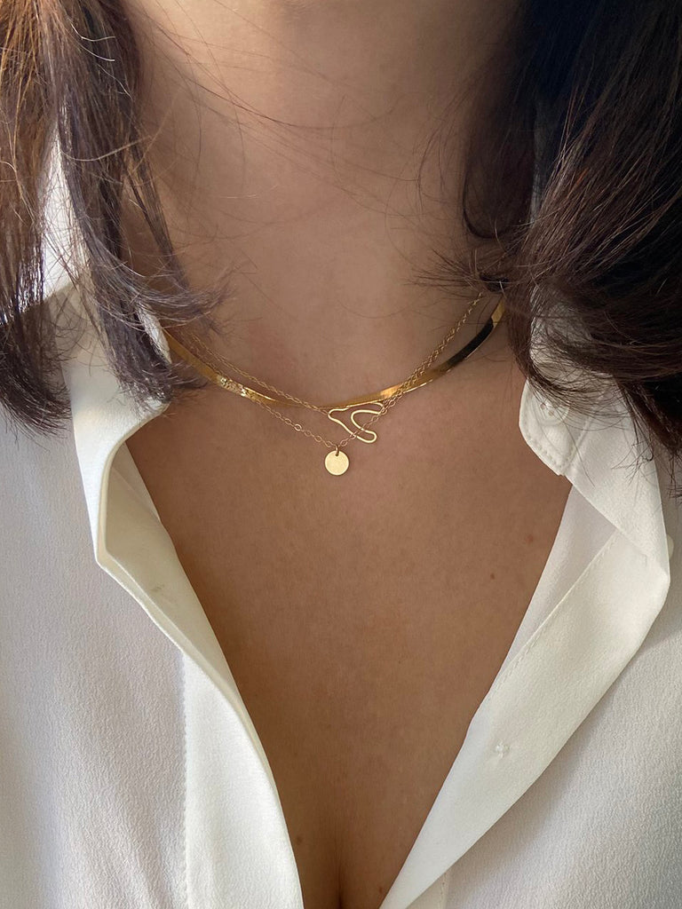 14k herringbone necklace layered with other necklaces